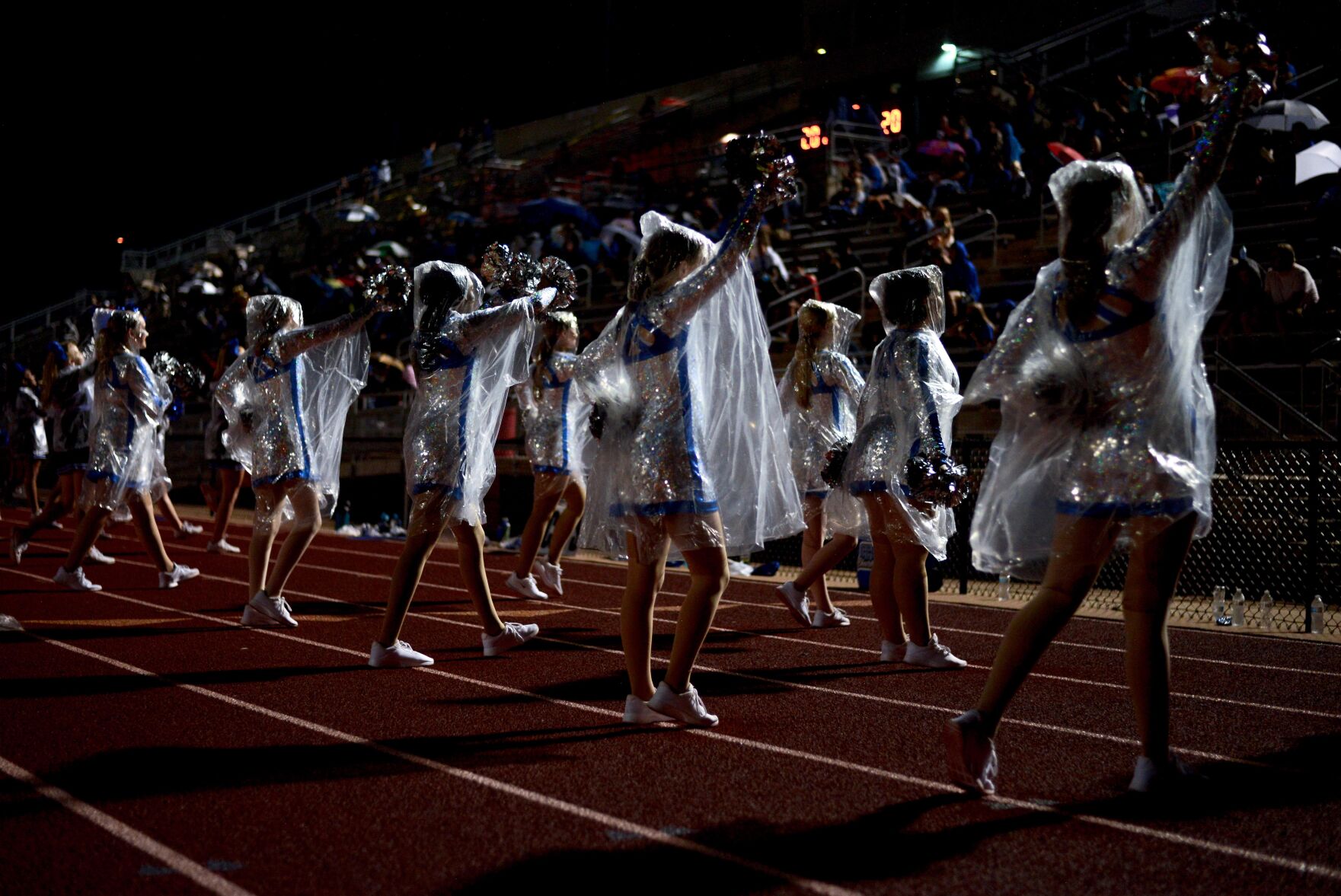 As the rain began for the evening, Capital City dance team cheers during a time out